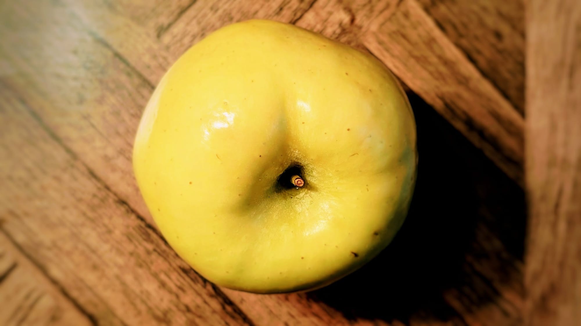 Top down view of a yellow apple.