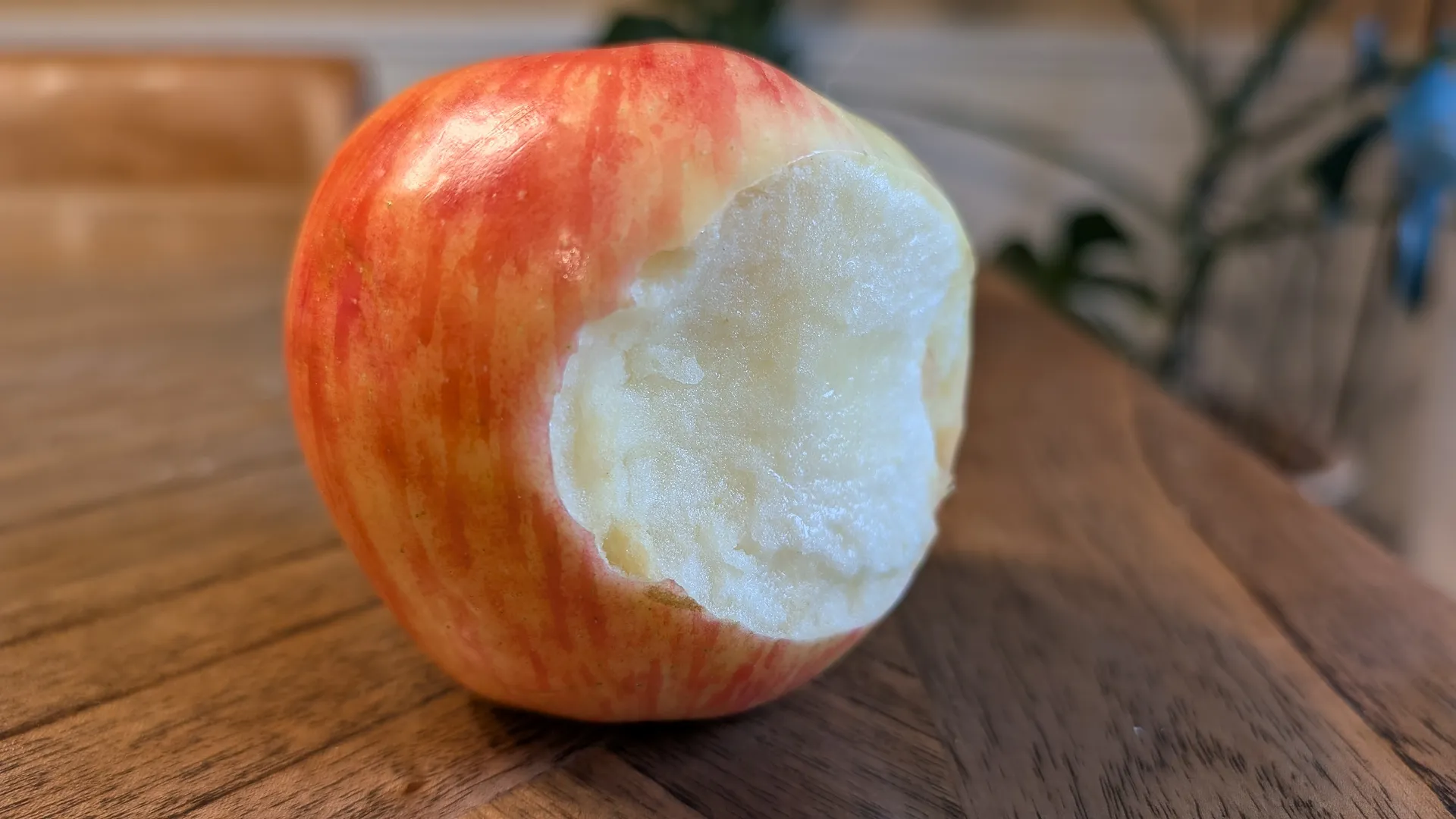 A honeycrisp apple with a bite taken.