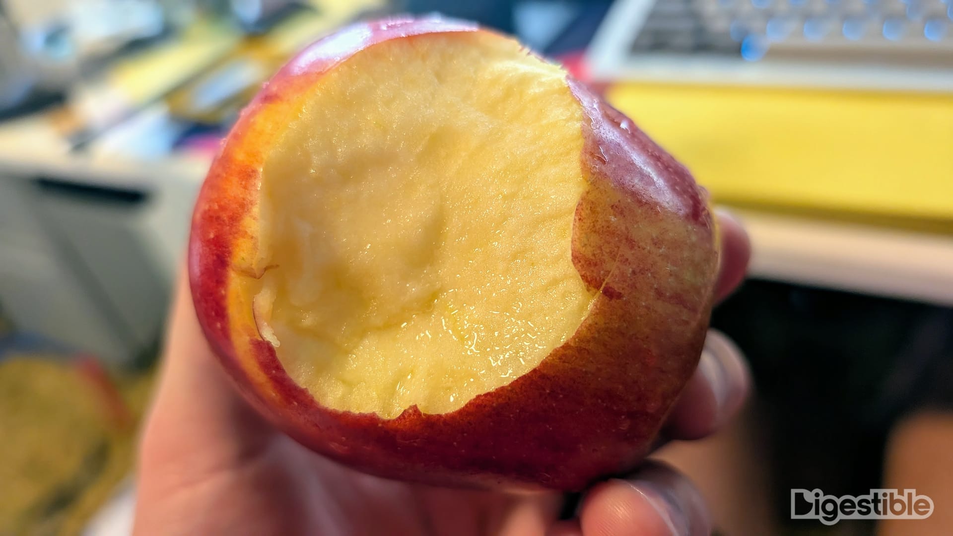 Bite taken out of a red apple.