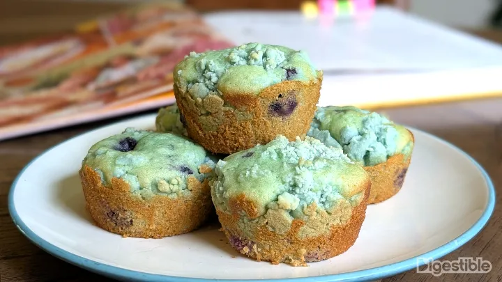 A stack of blue muffins on a plate.